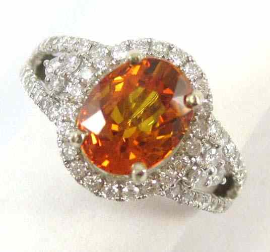 Appraisal: ORANGE SAPPHIRE AND DIAMOND RING k white gold featuring an