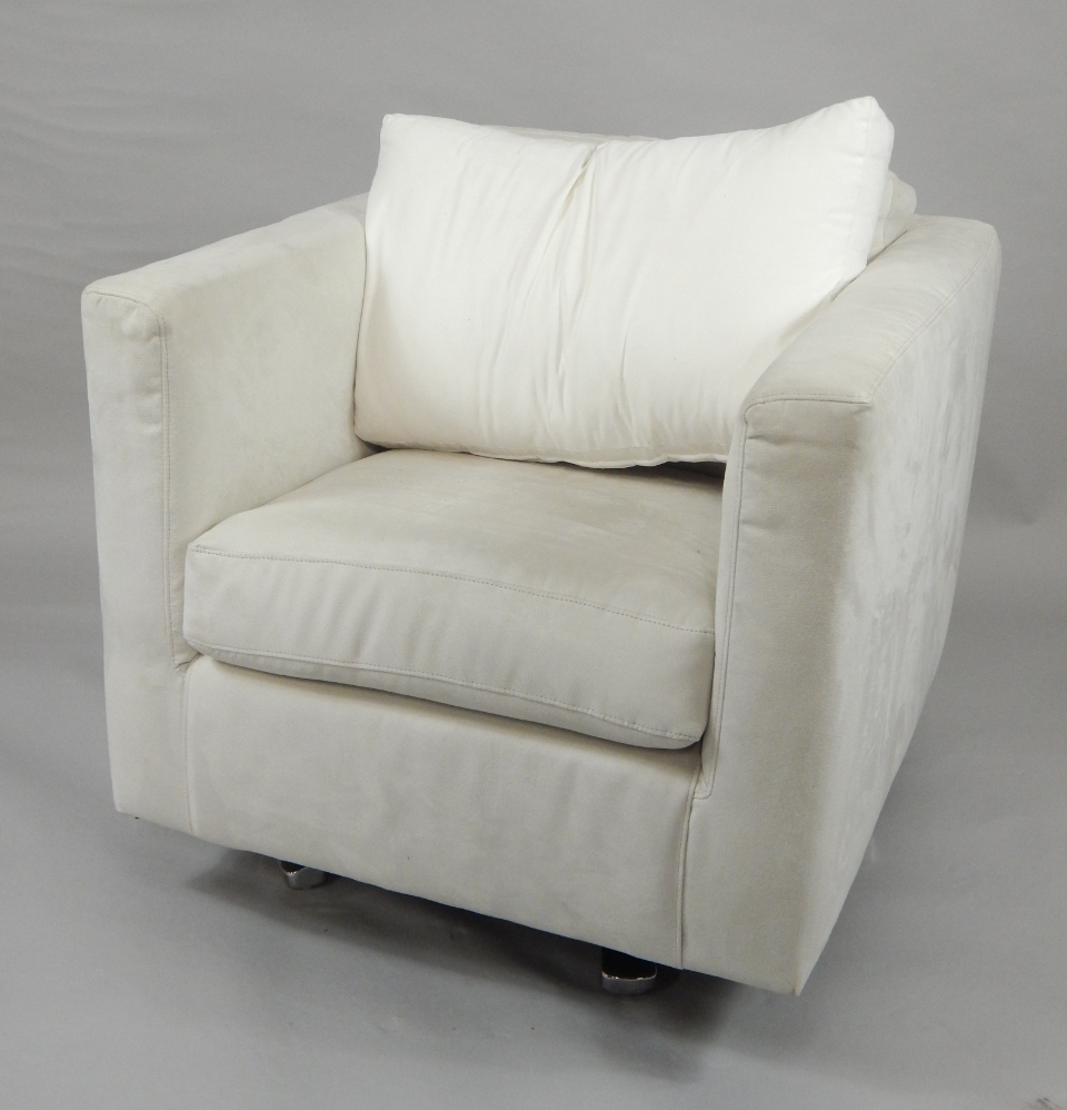 Appraisal: A swivel armchair upholstered in white suede with one loose