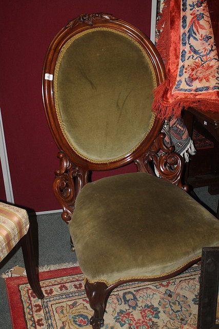 Appraisal: A LADY'S VICTORIAN WALNUT FRAMED FIRESIDE CHAIR with spoon back