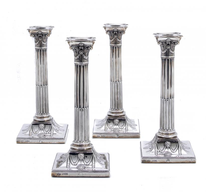 Appraisal: A SET OF FOUR VICTORIAN COLUMNAR CANDLESTICKS with beaded nozzle