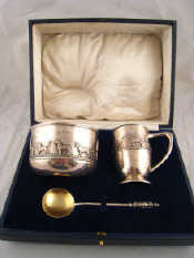 Appraisal: A boxed silver christening set comprising porringer spoon and mug