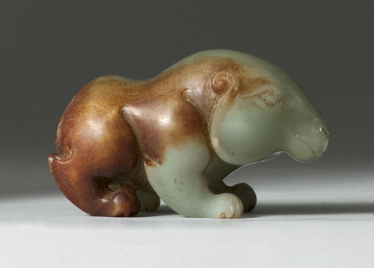 Appraisal: CELADON AND BROWN JADE CARVING Depicting a tapir in a