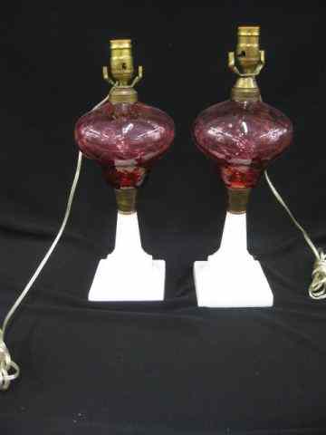 Appraisal: Pair of Cranberry Art Glass Lamps milk glass pedestal bases