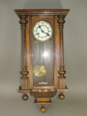 Appraisal: A Continental walnut cased regulator type wall clock the case