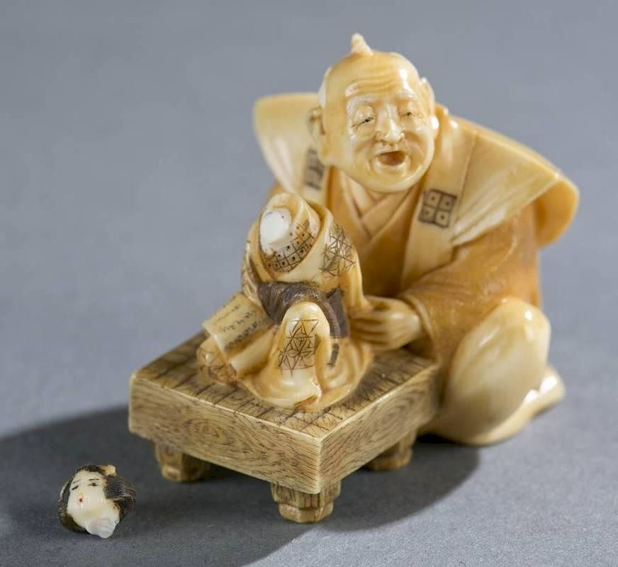 Appraisal: Japanese ivory netsuke of doll maker A Japanese ivory netsuke