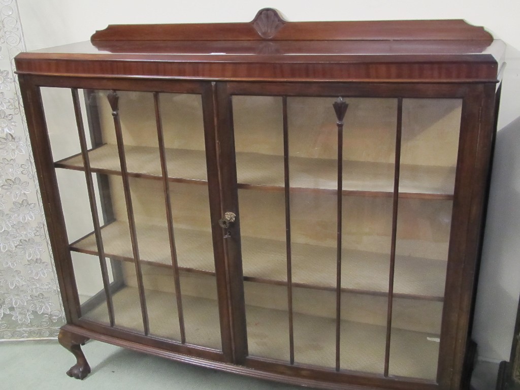 Appraisal: Mahogany display cabinet raised on ball and claw supports