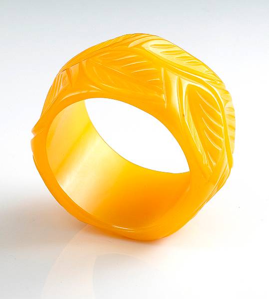 Appraisal: A bakelite carved leaf bangle bracelet of yellow-orange color