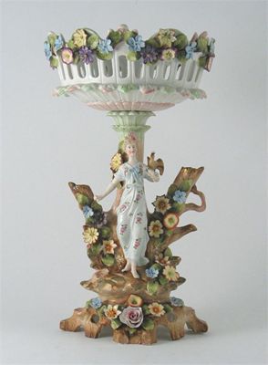 Appraisal: A Continental porcelain tazza applied with flowers the base mounted