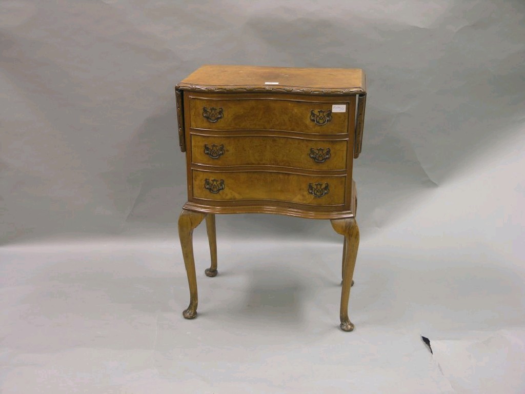 Appraisal: A burr walnut inverted serpentine fronted chest with a drop-leaf