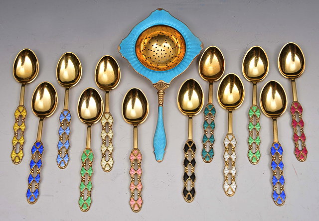 Appraisal: A SET OF TWELVE STANDARD SILVER GILT AND POLYCHROME ENAMEL