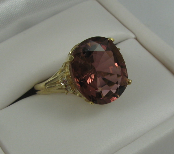 Appraisal: PINK TOURMALINE DIAMOND AND K GOLD RING centering an oval-cut