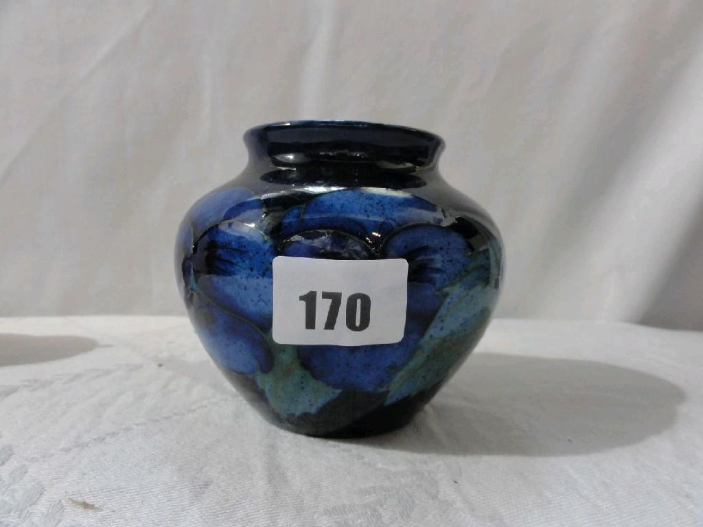 Appraisal: A Moorcroft blue ground vase with painted stylised pansy and