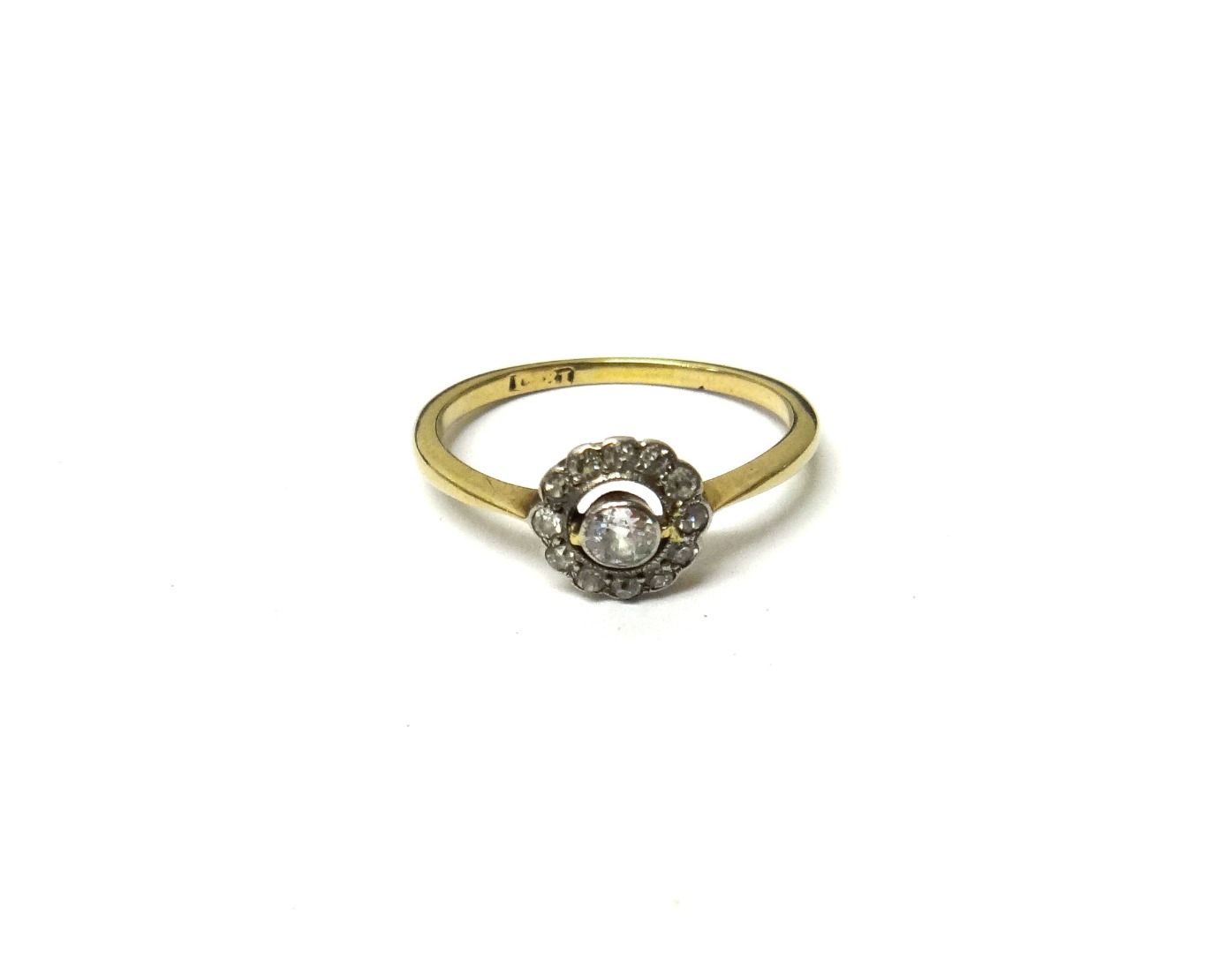 Appraisal: A gold and diamond cluster ring collet set with the