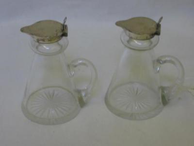 Appraisal: A PAIR OF GLASS WHISKY JUGS of tapering form the