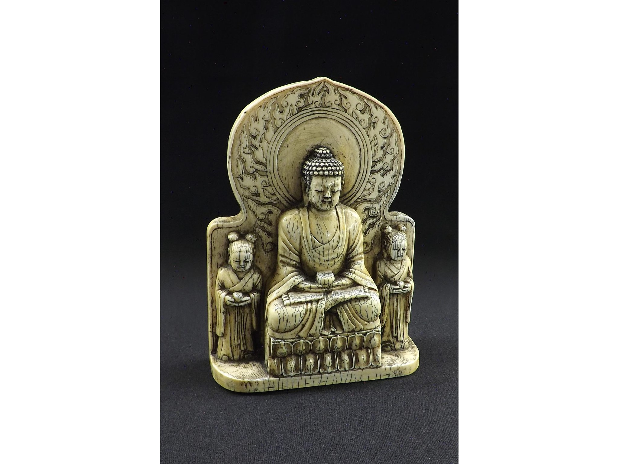 Appraisal: Chinese carved ivory group modelled with a deity seated in