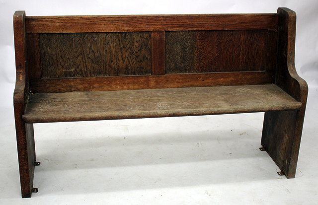 Appraisal: AN OAK PEW with panelled back cm wide