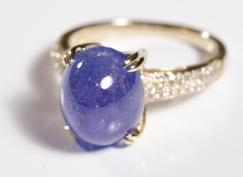 Appraisal: TANZANITE AND FOURTEEN KARAT GOLD RING with round-cut diamonds set