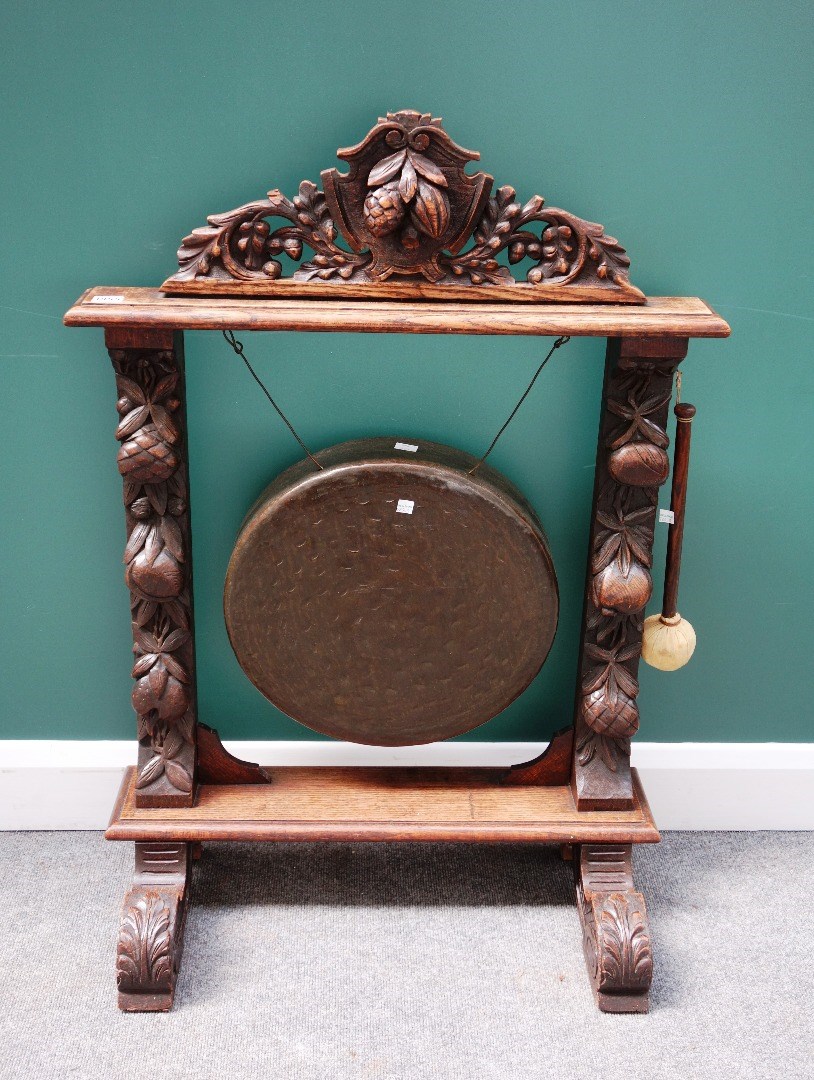 Appraisal: A Victorian oak framed dinner gong with carved fruiting frame