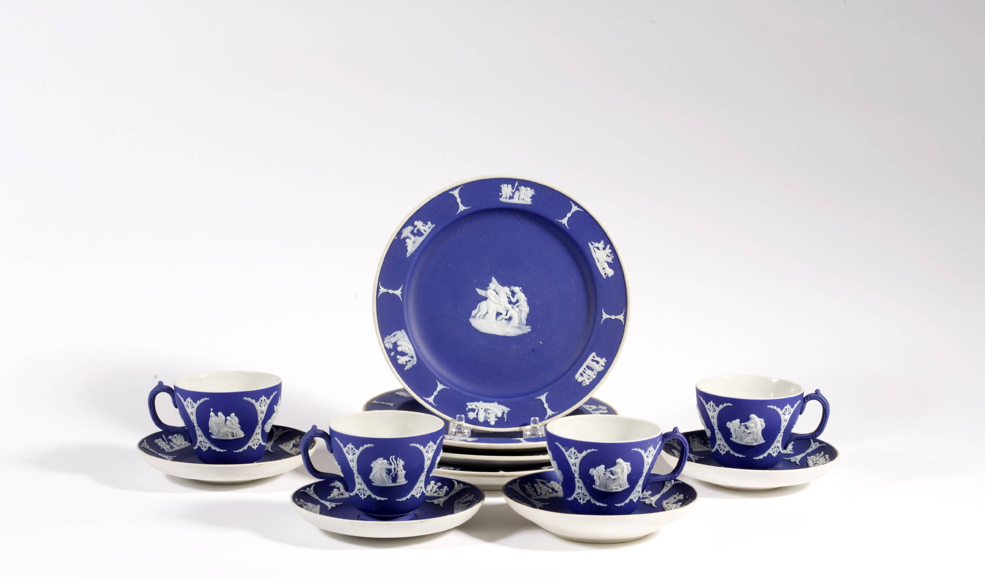 Appraisal: FOUR WEDGWOOD DARK BLUE AND WHITE JASPERWARE CUPS AND SAUCERS