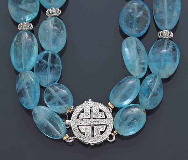 Appraisal: An aquamarine bead and diamond double strand necklace mounted in