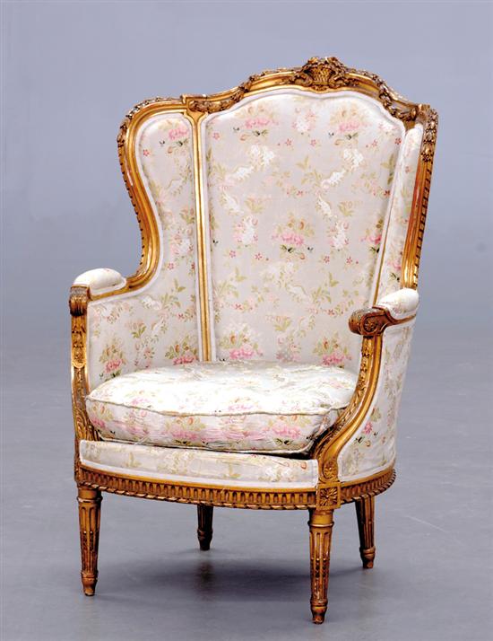 Appraisal: Louis XVI style carved giltwood wingback chair late th century