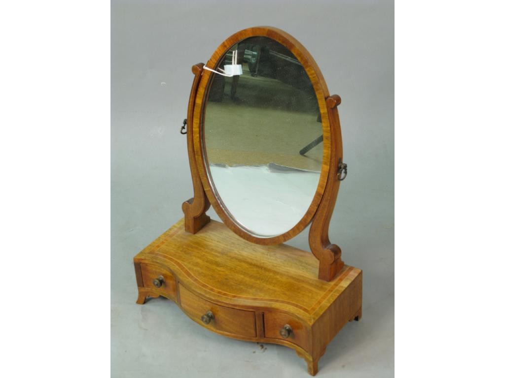 Appraisal: A reproduction mahogany toilet mirror oval plate above serpentine base