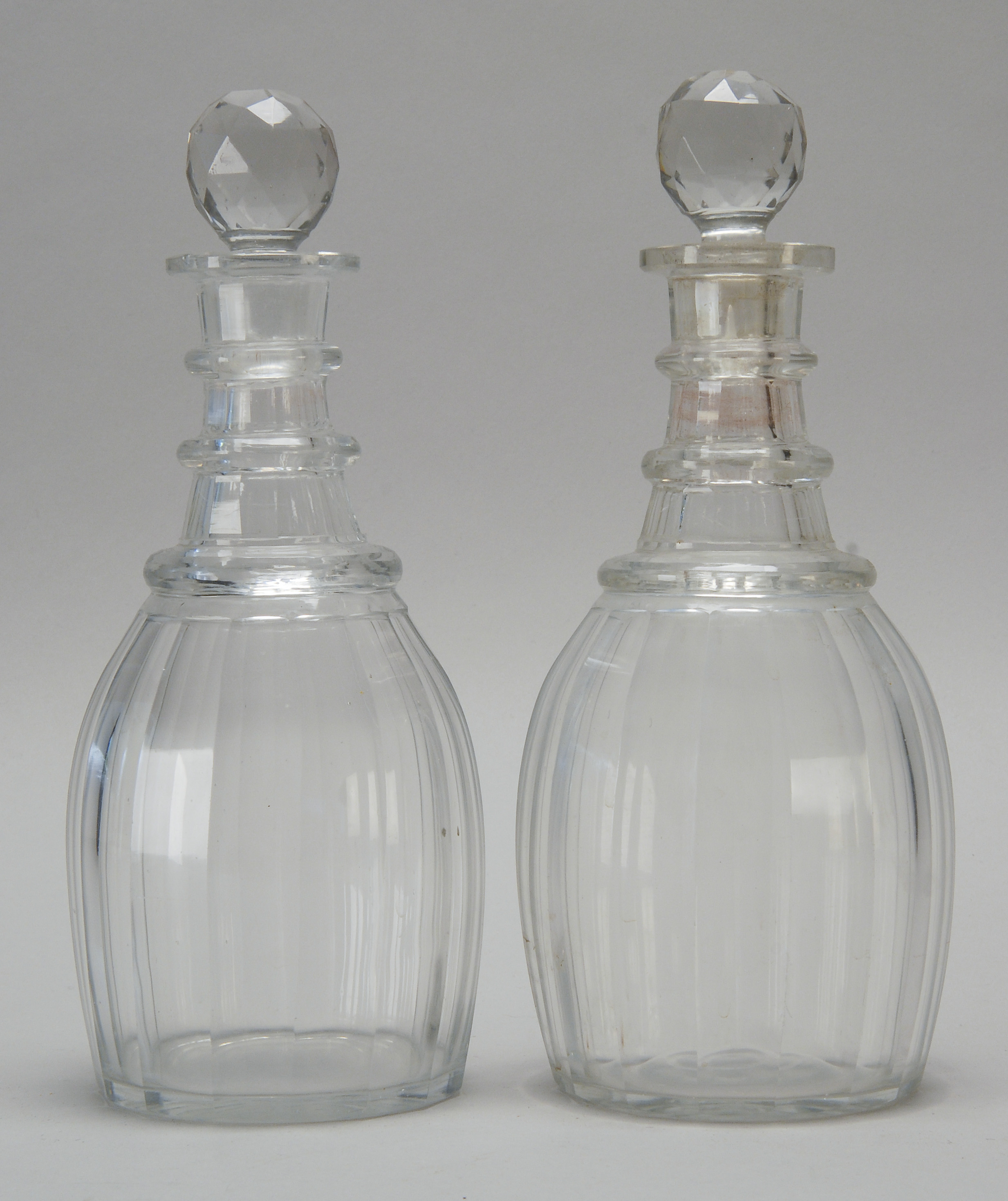 Appraisal: PAIR OF CLEAR BLOWN PANEL CUT GLASS DECANTERS th CenturyWith