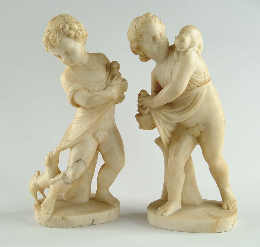 Appraisal: PAIR OF CARVED ALABASTER STATUES One shows child with puppy