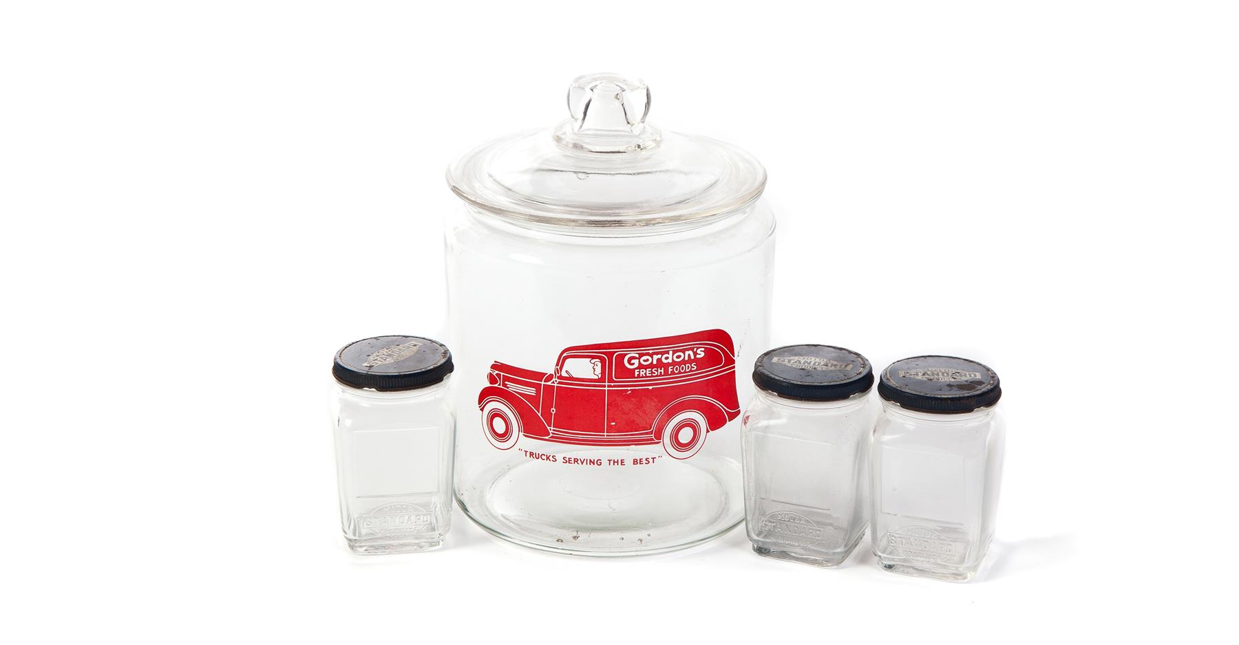 Appraisal: FOUR GLASS ADVERTISING JARS American mid-late th century Three jars