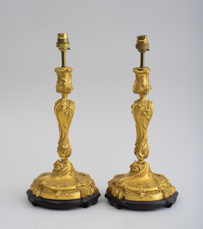 Appraisal: PAIR OF LOUIS XV STYLE GILT-BRONZE CANDLESTICKS Each baluster-shaped stem