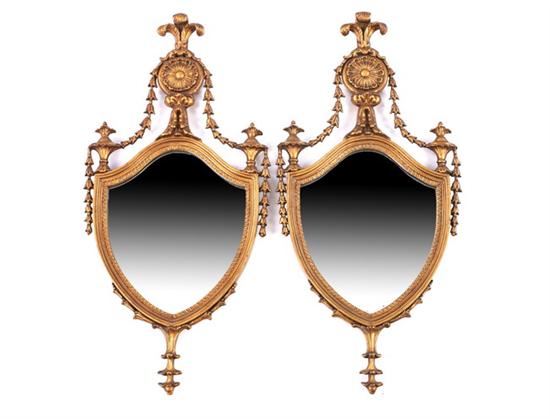 Appraisal: PAIR OF GILTWOOD NEOCLASSICAL SHIELD SHAPED MIRRORS th century Prince