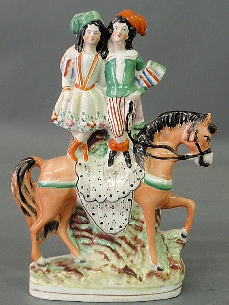 Appraisal: Staffordshire figural group of a boy and girl standing on