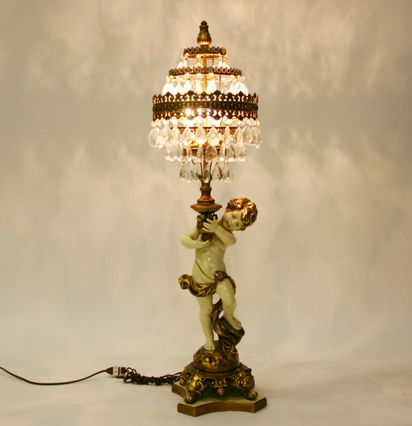 Appraisal: Cast metal cupid figure boudoir lamp five concentric tiers with