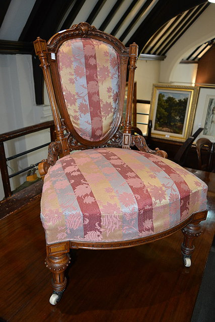 Appraisal: Victorian carved walnut gentleman's armchairwith striped upholstery and a similar