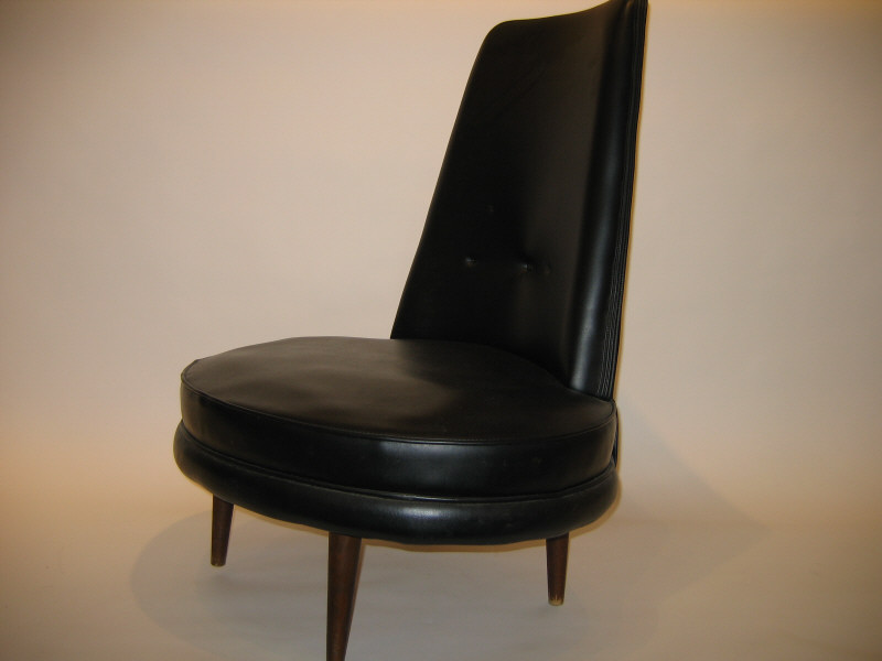 Appraisal: BLACK VINYL LOUNGE CHAIR with concave back oval seat raised