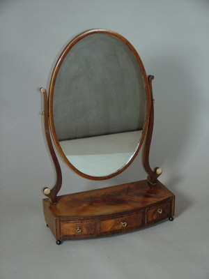 Appraisal: A mahogany and inlaid bowfront dressing table mirror th century