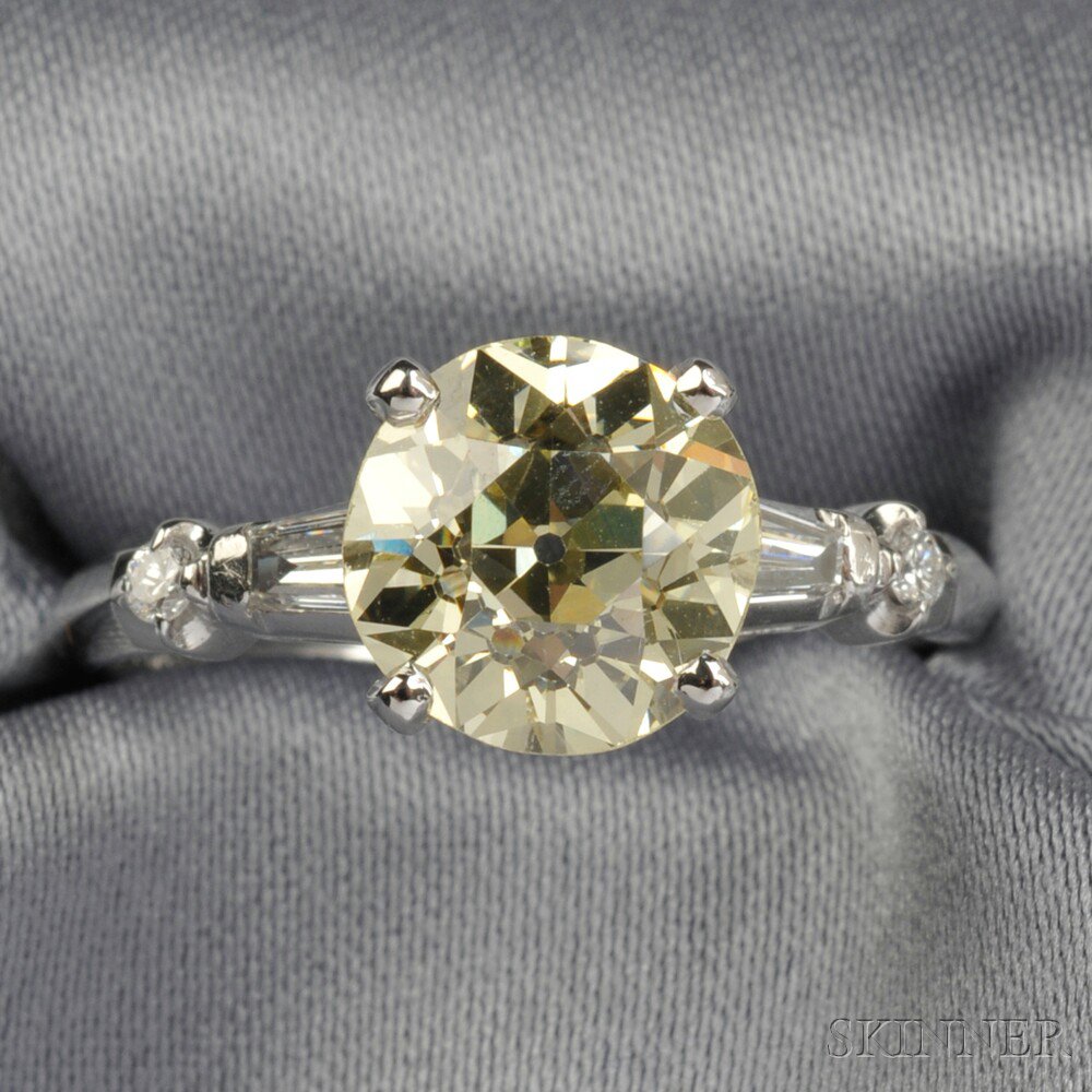 Appraisal: Platinum and Colored Diamond Solitaire prong-set with an old European-cut