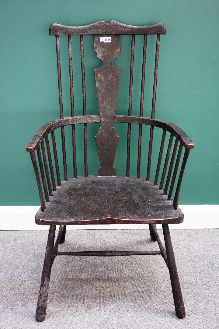 Appraisal: A George III style black painted comb back Windsor chair