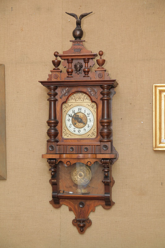 Appraisal: WALL CLOCK Eight day time strike with brass works and