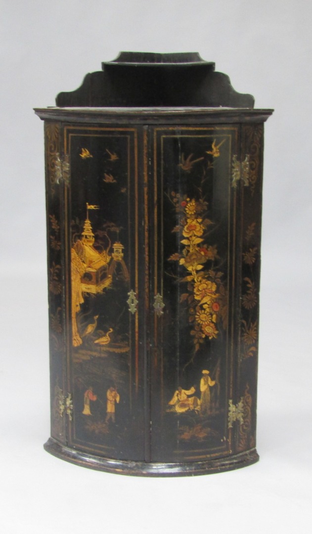 Appraisal: A Regency Japanned lacquer bow fronted wall mounted corner cupboard