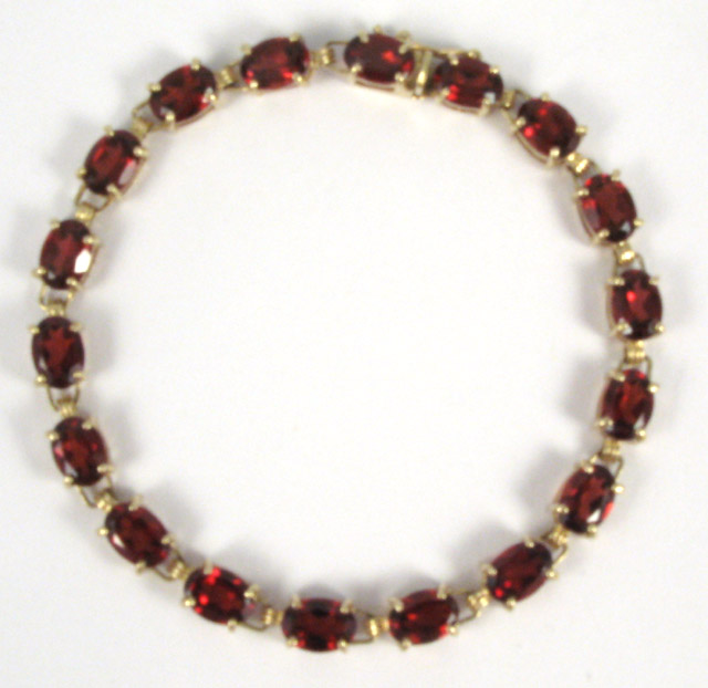 Appraisal: GARNET AND TEN KARAT GOLD BRACELET in length and set