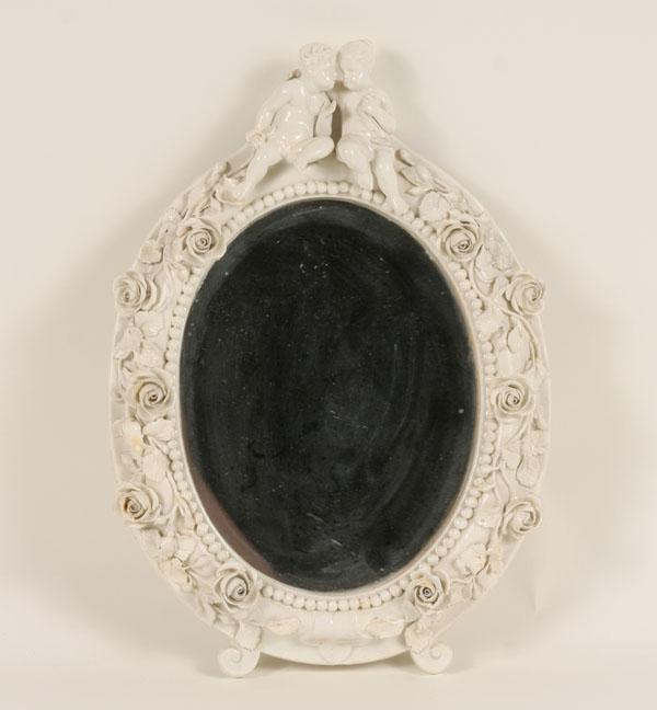 Appraisal: An English Fulham ceramic framed mirror the frame adorned with