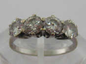 Appraisal: A diamond four stone ring the four brilliants totalling approx