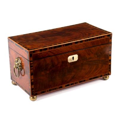 Appraisal: A Regency mahogany and crossbanded tea caddy fitted two hinged