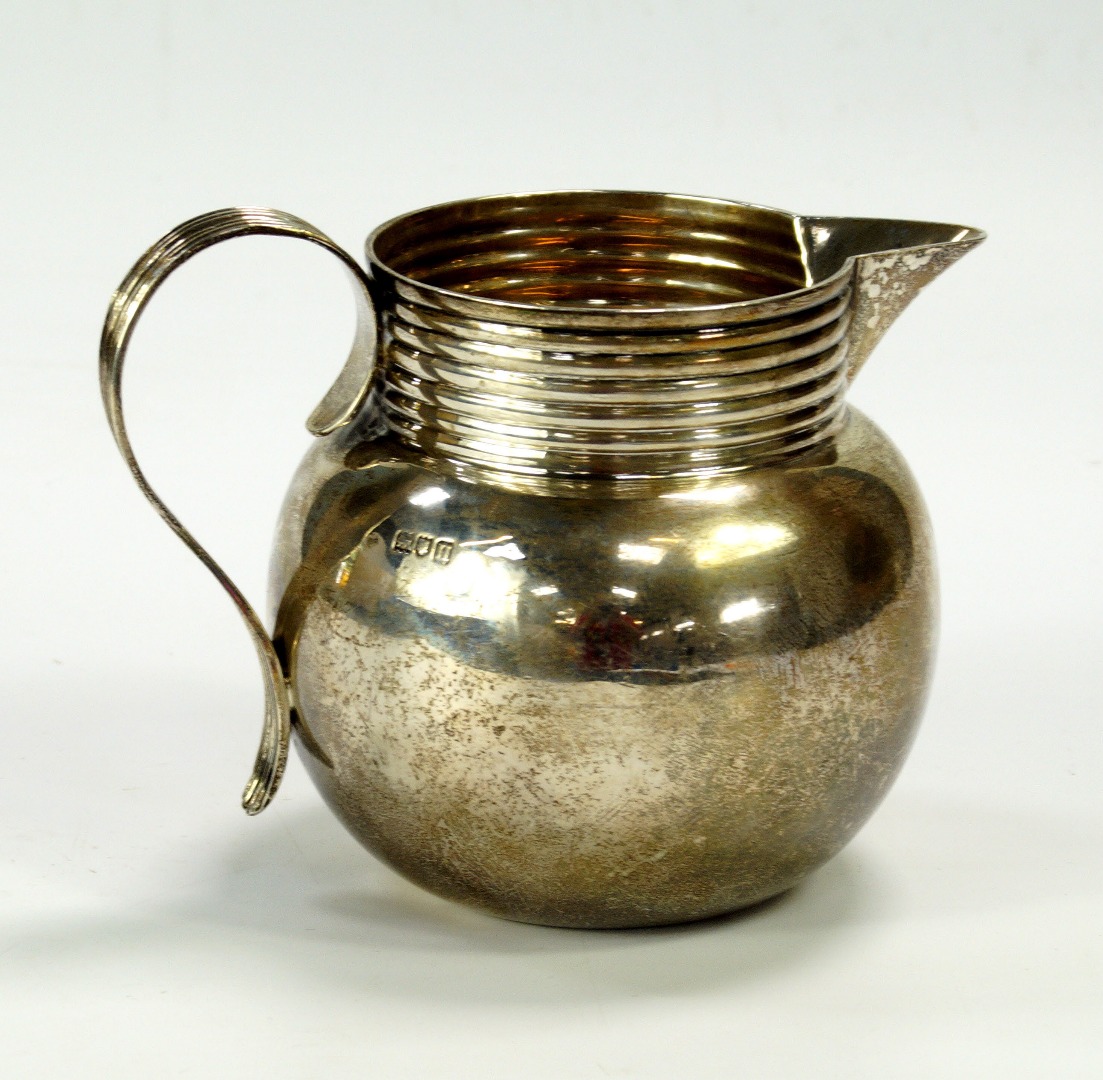 Appraisal: A George V silver milk jug with reeded handle London