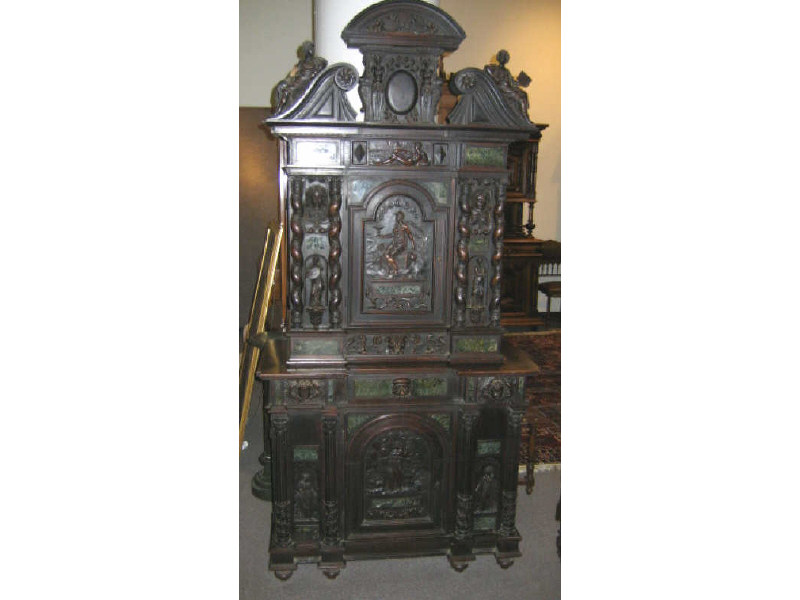 Appraisal: RENAISSANCE STYLE TWO-MEMBER WALNUT CABINET Elaborately carved allover the three