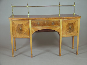 Appraisal: A Regency mahogany bowfront sideboard the brass gallery rail above