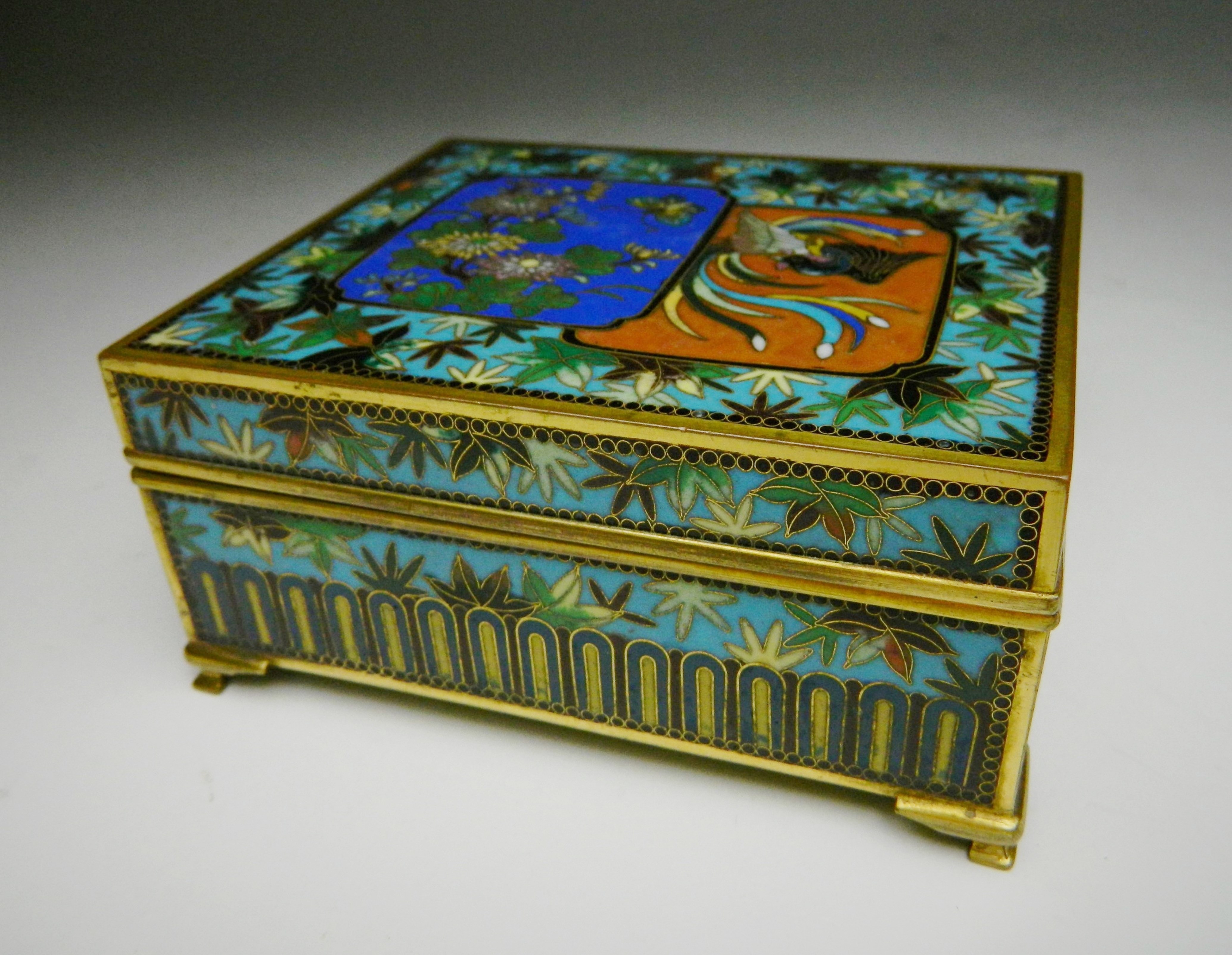 Appraisal: Japanese cloisonne box- two panel motifs one floral one phoenix