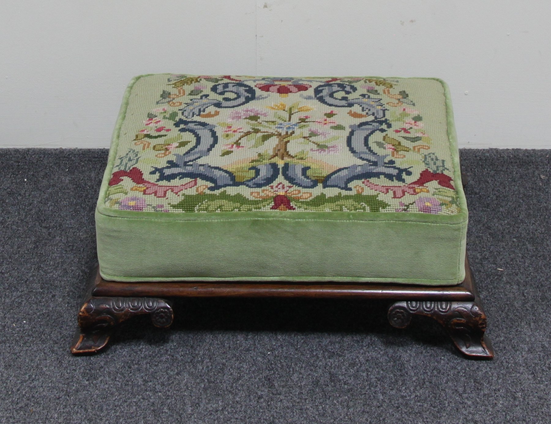 Appraisal: A tapestry covered footstool of square shape with carved feet