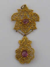 Appraisal: A filigree yellow metal tests gold and cabochon amethyst Eastern